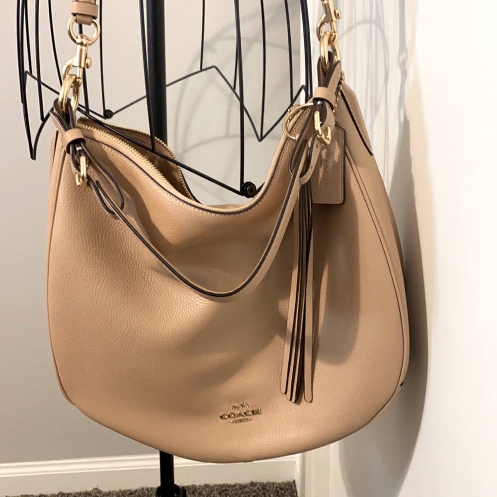 Tan/pinkish coach hobo NWOT. Bought a year ago and never used.